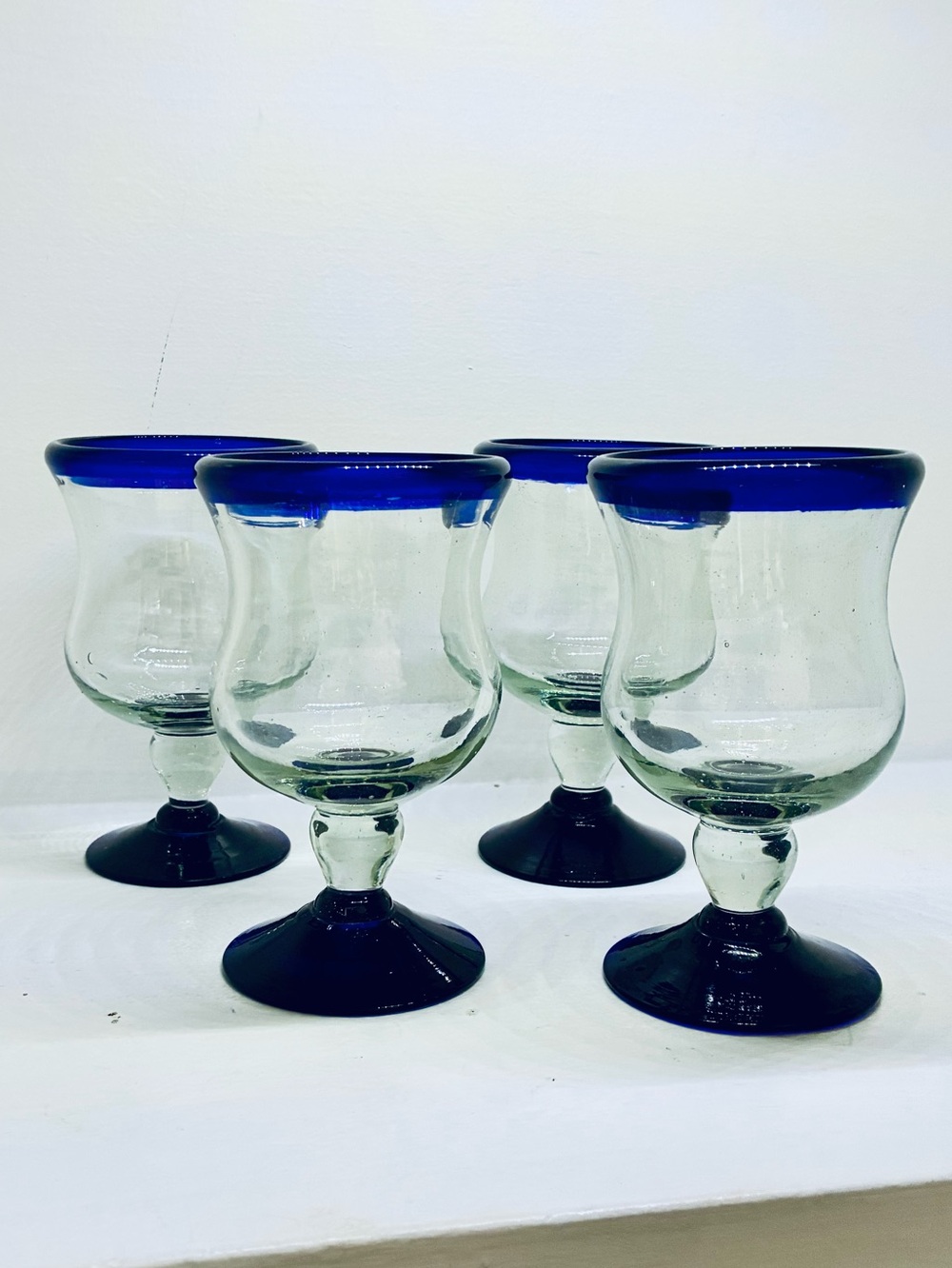 Set of 4 Mexican handblown glass goblets cobalt blue rim and base.
